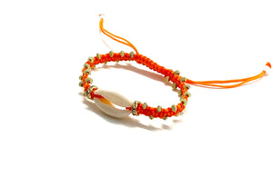 Natural shell bracelet with gold toupee on orange braided cord