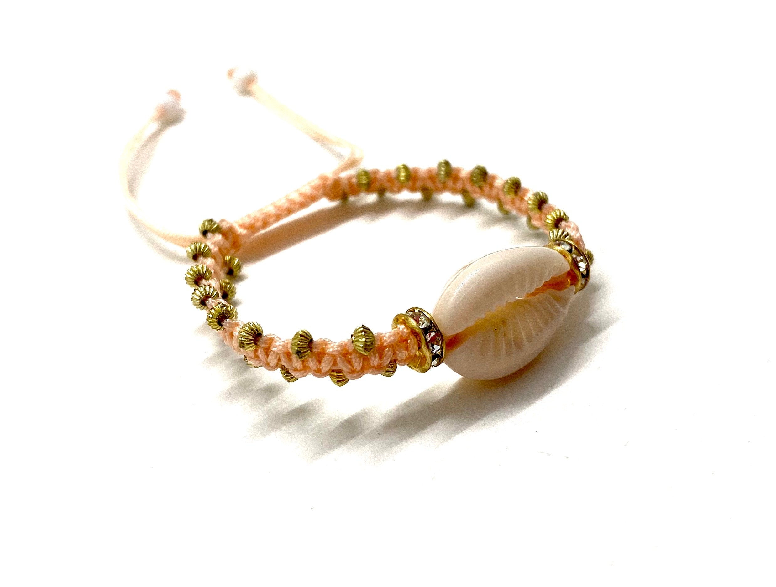 Natural shell bracelet pastel peach cord, gold toupee