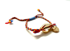 Gold shell bracelet, 'cotton perlé' with mustard, blue, and red braided cord