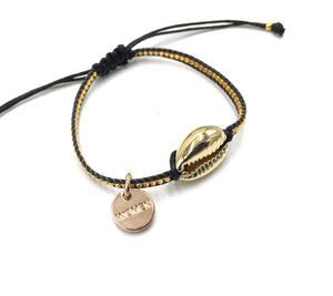 Gold shell bracelet, with gold Miyuki beads, and black cord.