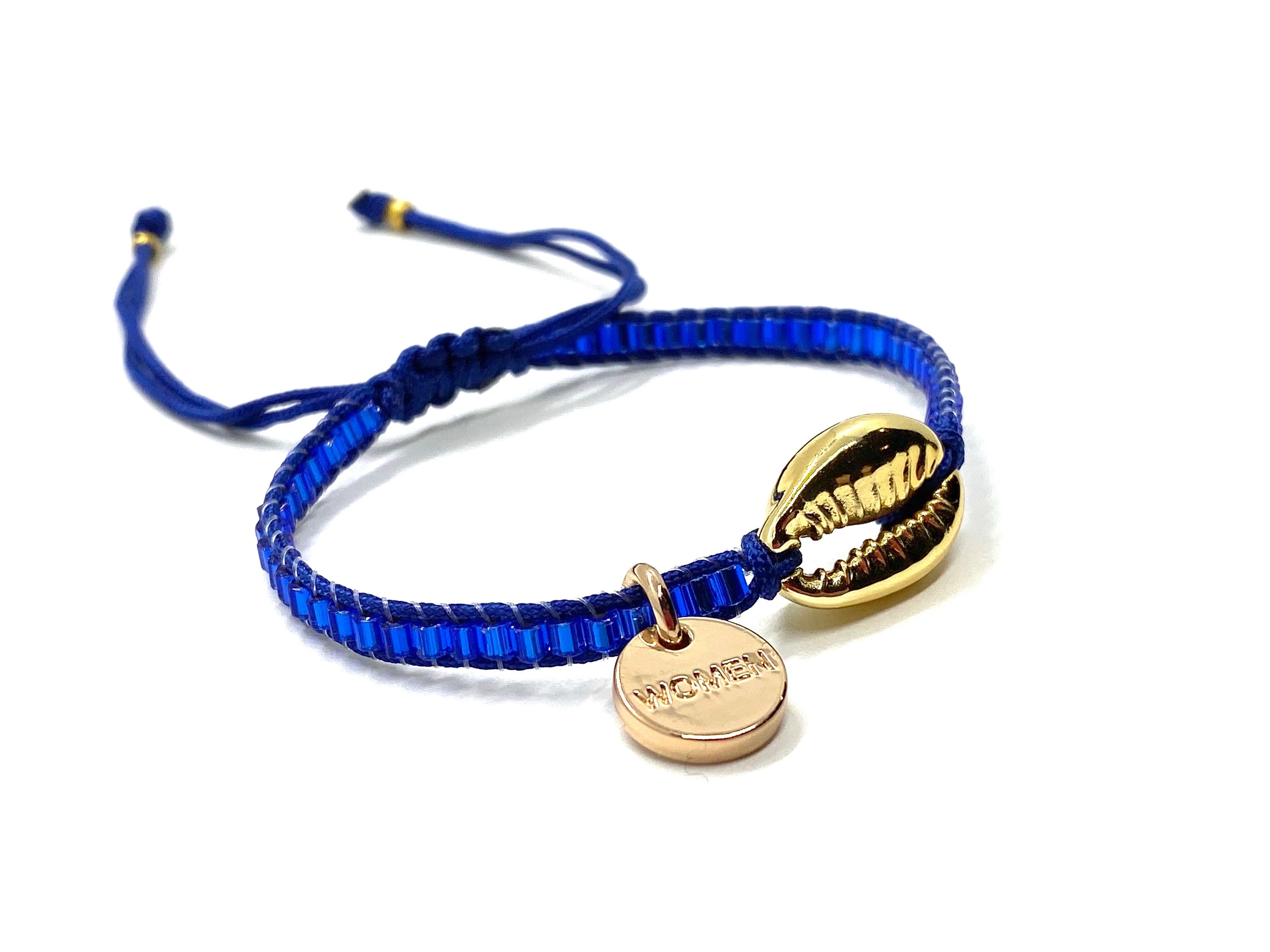 Gold Shell bracelet, with shiny blue seed beads and blue cord.