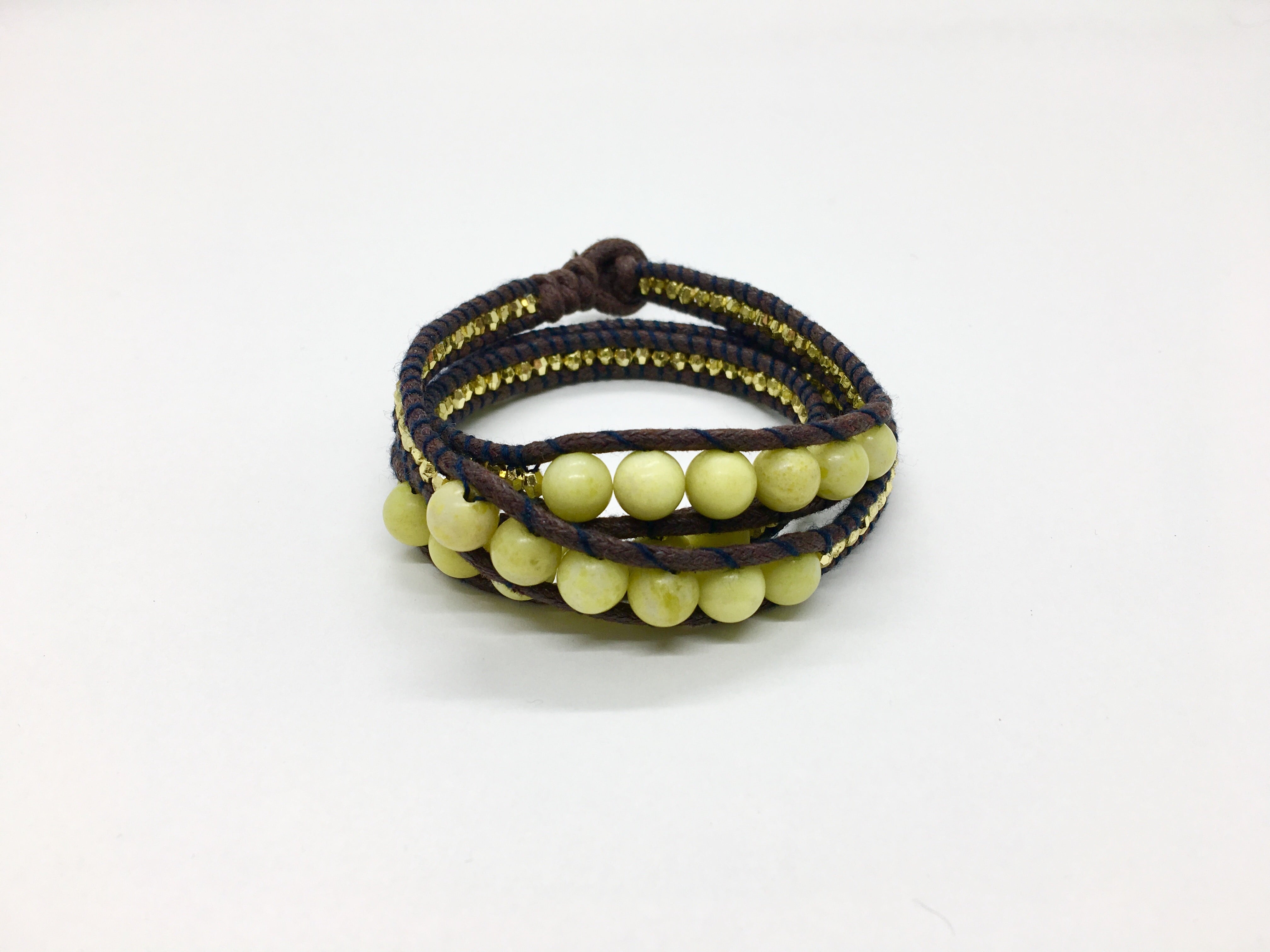 Wraparound Bracelet pale yellow stone, gold resin side beads, brown cord black thread.