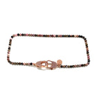 Clip to impact, lace rhodonite round stone with rose gold zirconia studded clasp.