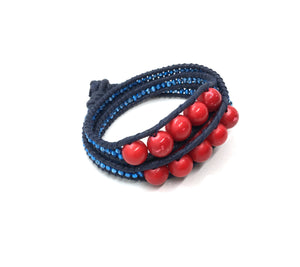 Wraparound red stone bracelet, metalic blue resin side bead, dark blue cord, dark blue thread.