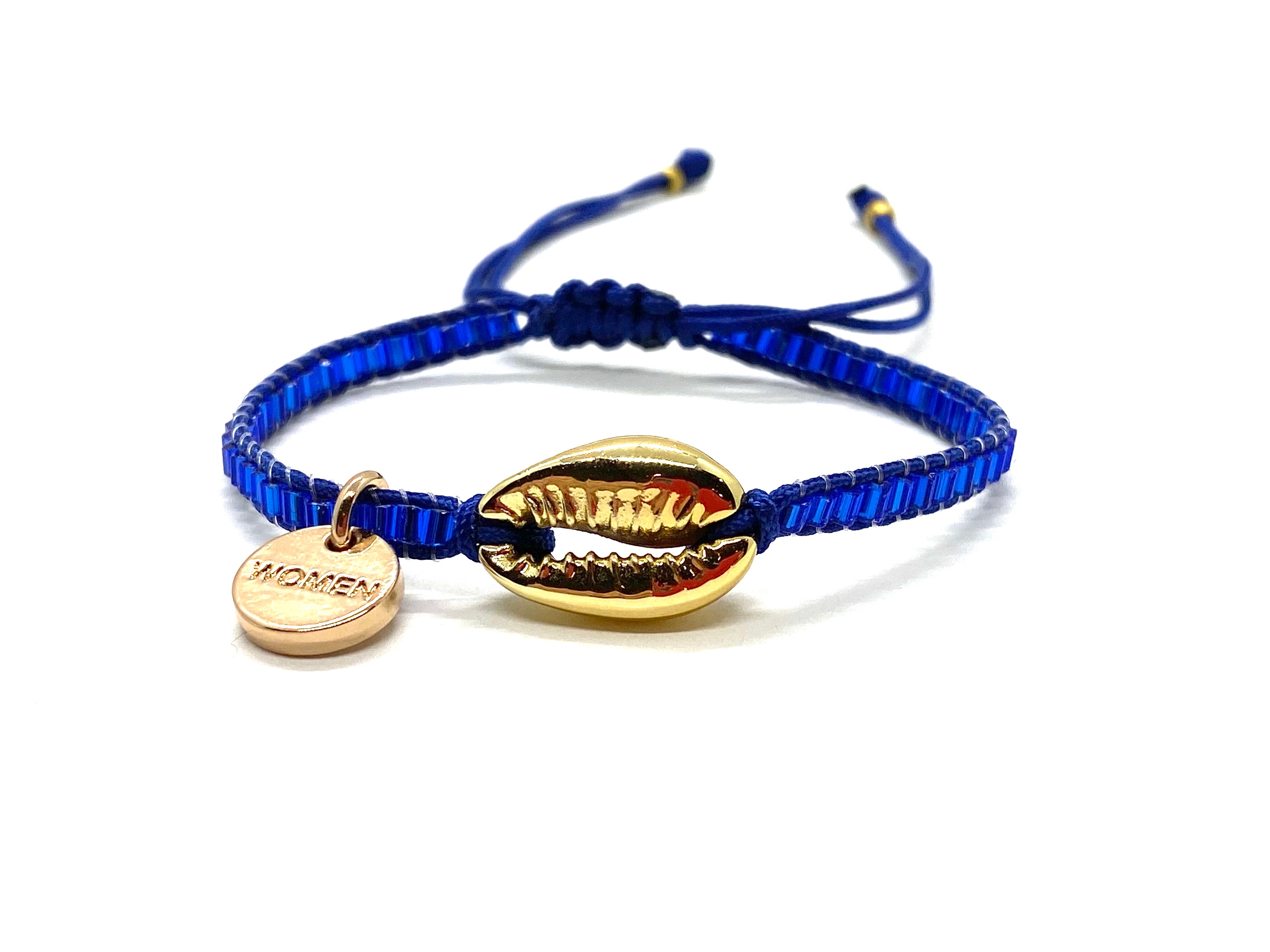 Gold Shell bracelet, with shiny blue seed beads and blue cord.