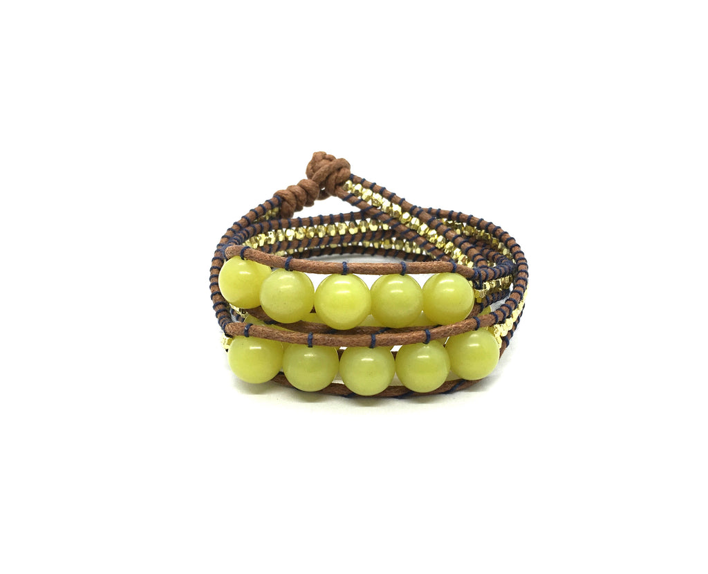 Wraparound Bracelet pale yellow translucent stone, gold resin bead side bead, brown cord black thread.