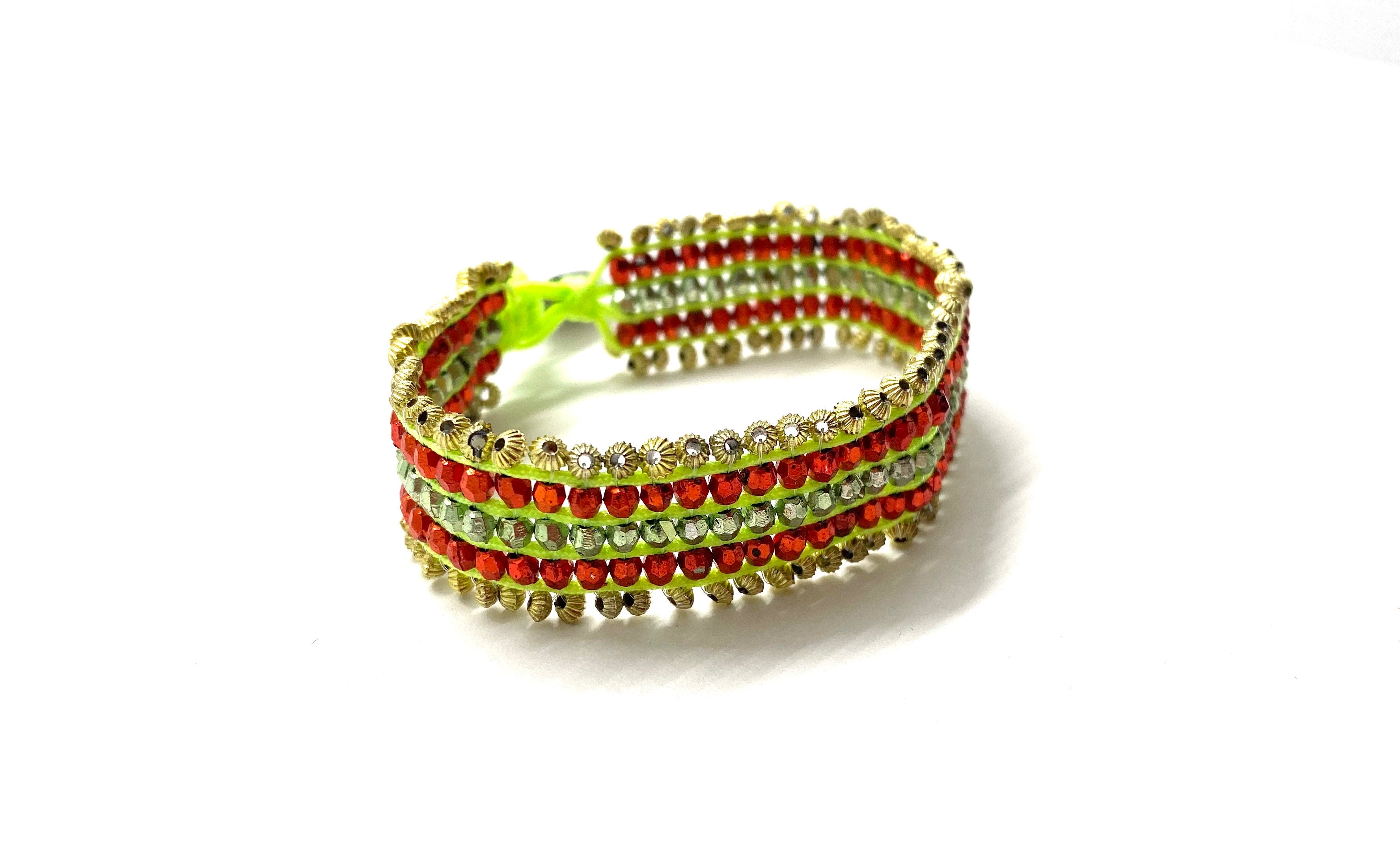 Beaded bracelet, gold and red beads fluo green cord.