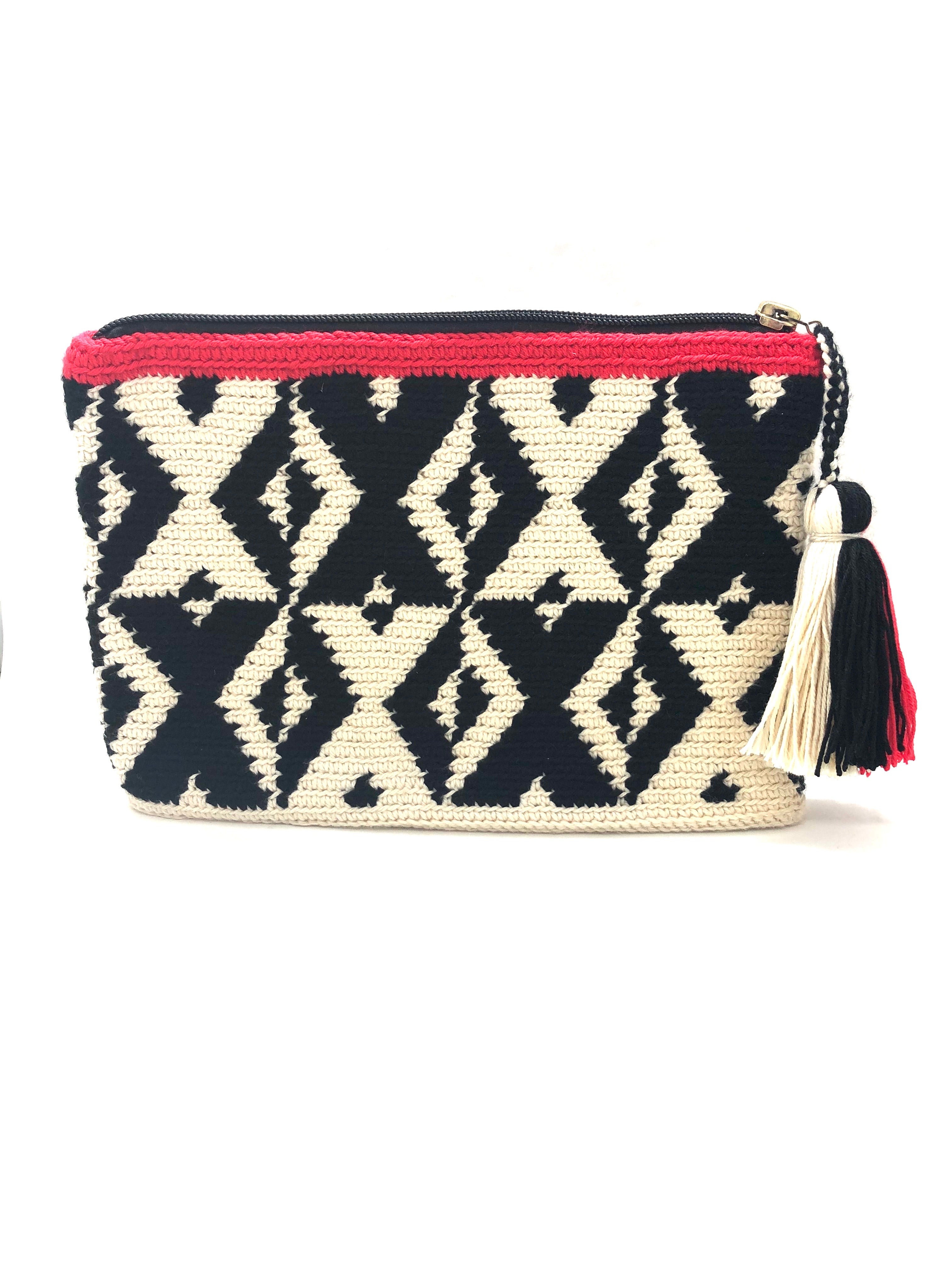 X pattern clutch, black and cream with red trim and tassel.