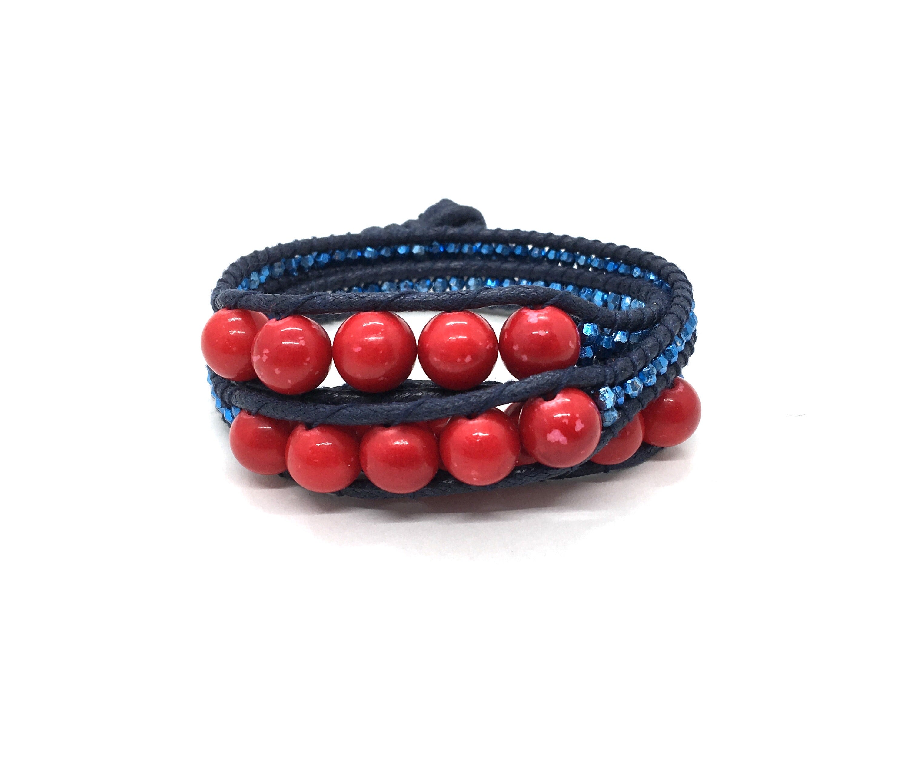 Wraparound red stone bracelet, metalic blue resin side bead, dark blue cord, dark blue thread.