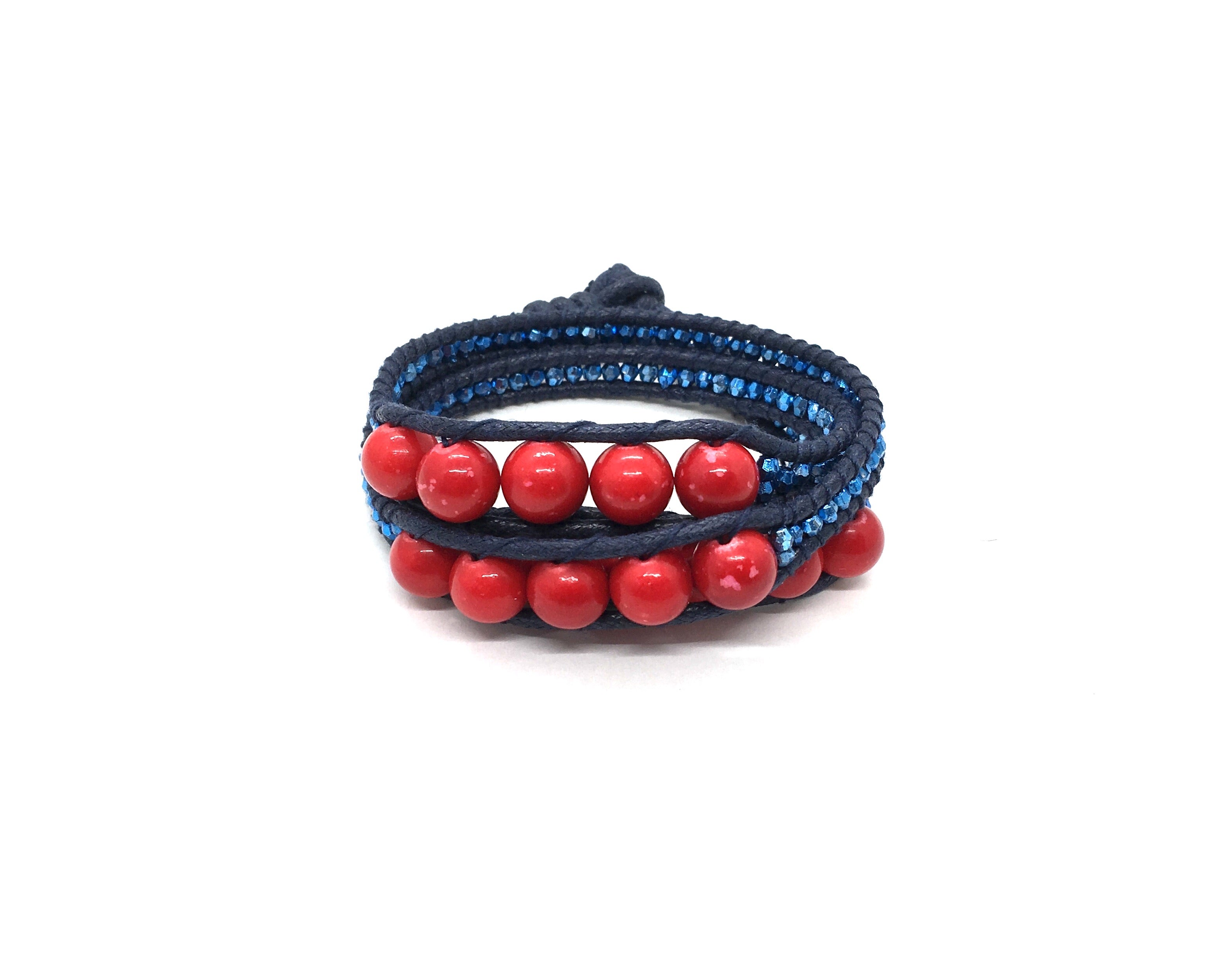 Wraparound red stone bracelet, metalic blue resin side bead, dark blue cord, dark blue thread.