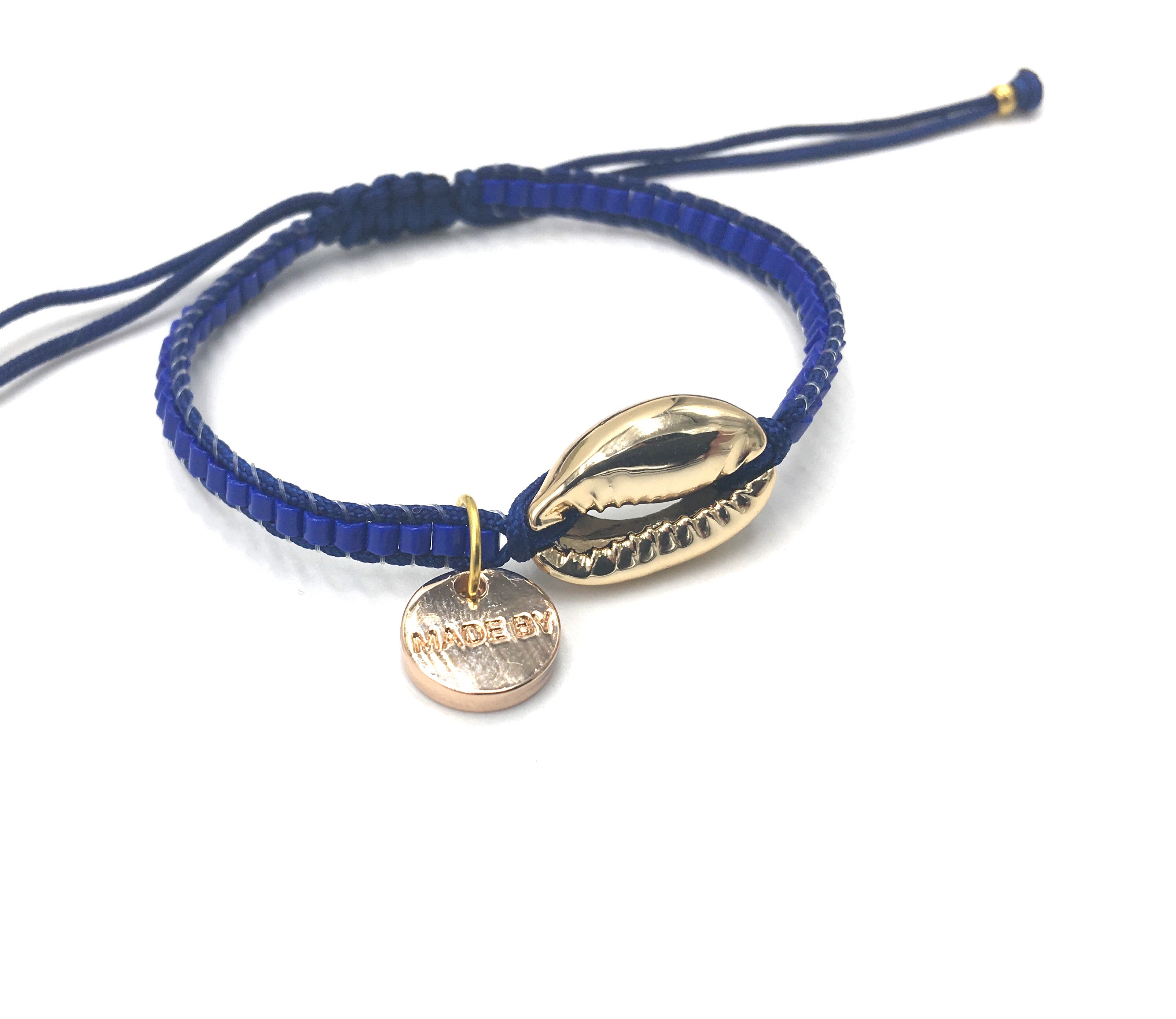 Gold Shell bracelet, mat blue seed beads and dark blue cord.