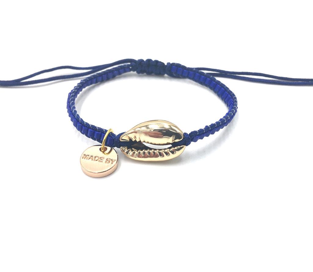 Gold Shell bracelet, mat blue seed beads and dark blue cord.